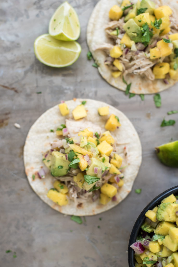 Zesty Jamaican Jerk Chicken tacos made in the slow cooker served with a sweet and delicious fresh mango salsa! 