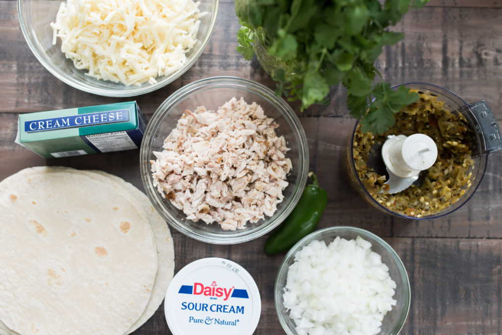 Hatch Green Chile Enchiladas smothered in a delicious sour cream sauce. Stuffed with Shredded chicken and spinach; Also Freezer Friendly! 