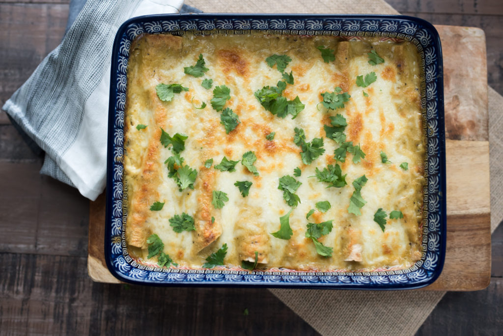 Hatch Green Chile Enchiladas smothered in a delicious sour cream sauce. Stuffed with Shredded chicken and spinach; Also Freezer Friendly! 