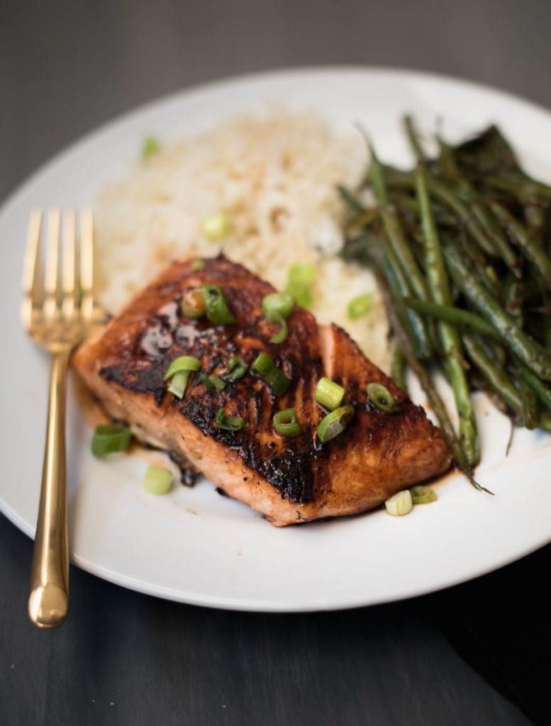 An easy 5 ingredient honey Sriracha salmon dish. A little sweet, a little spicy, and really tasty! The salmon cooks fast on the stove and is great served over rice with your favorite green vegetable. | Firstandfull.com