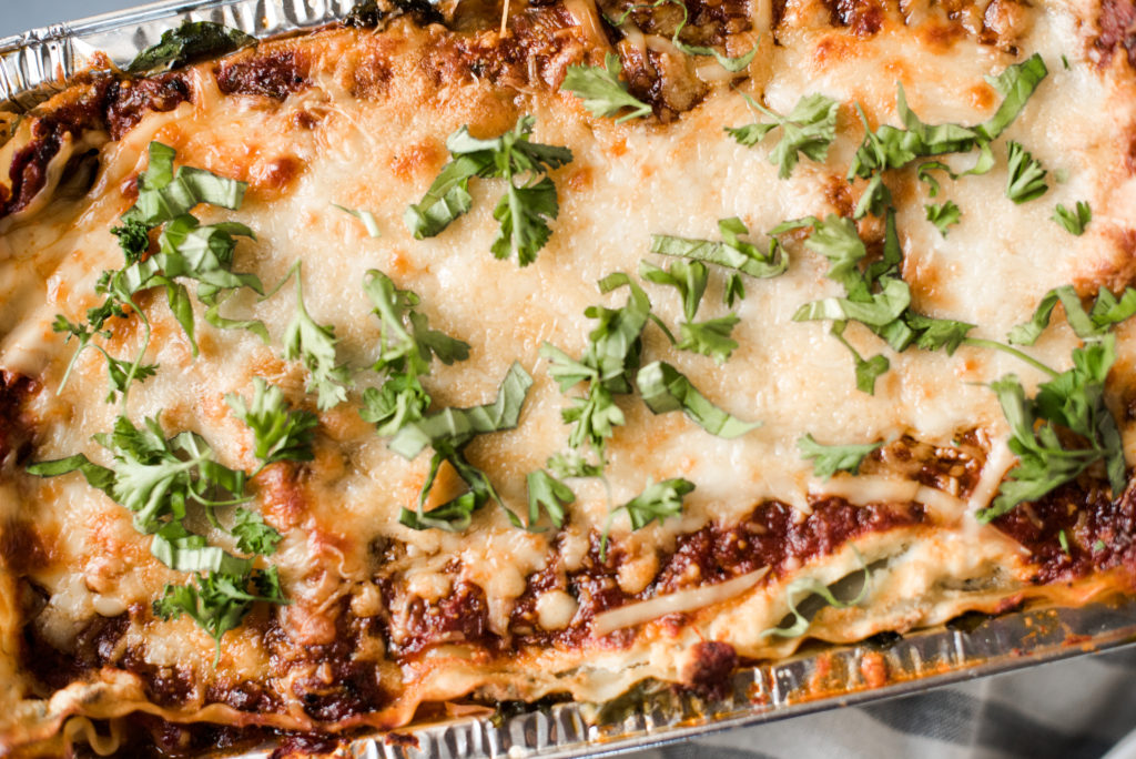 Vegetarian spinach lasagna recipe; layers stuffed with spinach and kale, a savory ricotta, and layered with mozzarella cheese. Make one for the freezer for an easy weeknight meal. 