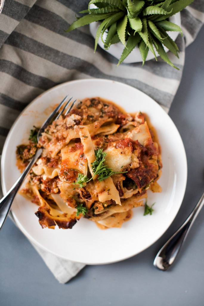 Vegetarian spinach lasagna recipe; layers stuffed with spinach and kale, a savory ricotta, and layered with mozzarella cheese. Make one for the freezer for an easy weeknight meal. 