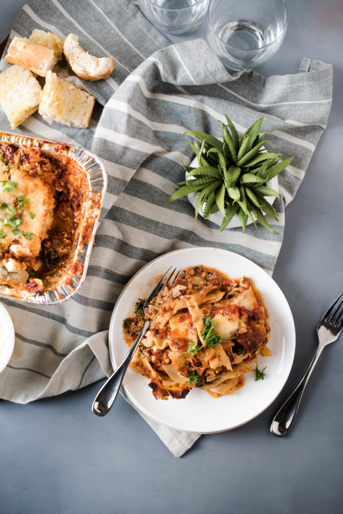 Vegetarian spinach lasagna recipe; layers stuffed with spinach and kale, a savory ricotta, and layered with mozzarella cheese. Make one for the freezer for an easy weeknight meal. 