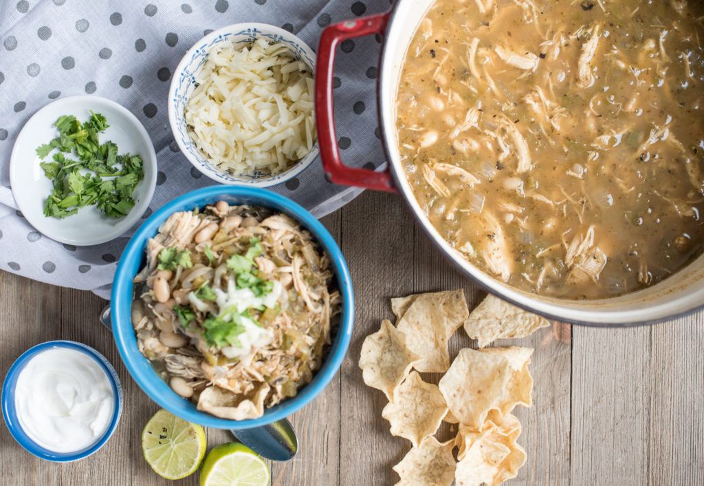 White Chicken Chili: Light, Flavorful soup with white beans, tender shredded chicken, roasted peppers, topped w/ cilantro, cheese, avocado, and lime juice.