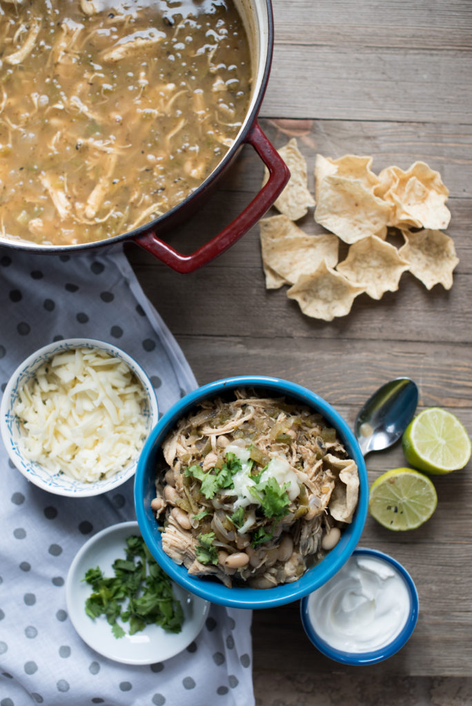 White Chicken Chili: Light, Flavorful soup with white beans, tender shredded chicken, roasted peppers, topped w/ cilantro, cheese, avocado, and lime juice.