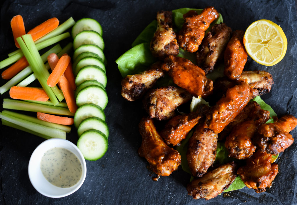 Traditional hot wings with a little zing! Crispy Lemon Pepper hot wings seasoned with lemon garlic seasoning, tossed with a traditional buffalo wing sauce served with a squeeze of lemon juice. 