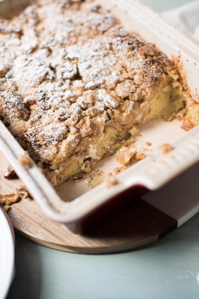 This stuffed cinnamon roll French toast has all the flavors of a homemade cinnamon roll but without all the effort. Sweet, eggy custard poured over brioche bread, stuffed with a sweet cream cheese, topped with a crunch streusel. Heaven in a casserole dish!