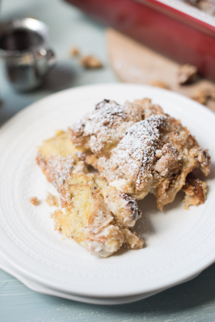 This stuffed cinnamon roll French toast has all the flavors of a homemade cinnamon roll but without all the effort. Sweet, eggy custard poured over brioche bread, stuffed with a sweet cream cheese, topped with a crunch streusel. Heaven in a casserole dish!