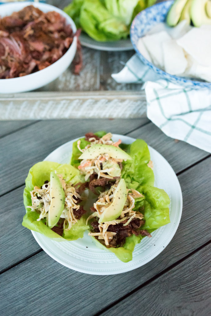 This Crispy Pulled Pork Dinner comes together in less than 10 minutes. Whole30 Compliant pulled pork, seasoned with southwestern spices, loaded in crisp lettuce cups topped with my signature creamy chipotle slaw make for a delicious meal. Clean eating made tasty and easy! 
